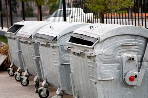 Workers sorting different types of builders waste