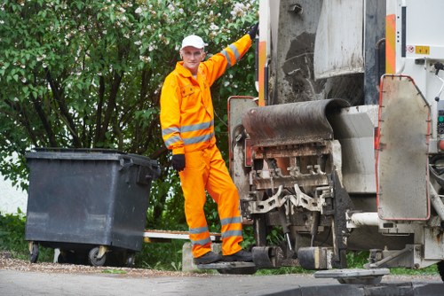 Crew loading mixed office waste into a transit van on a city street