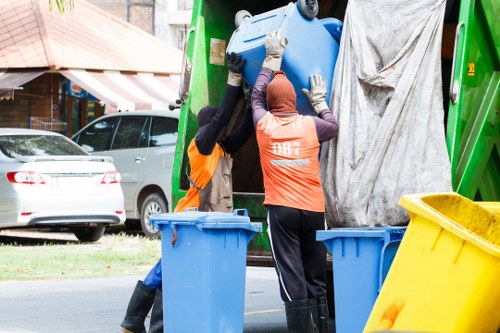 Training session for waste removal staff demonstrating manual handling